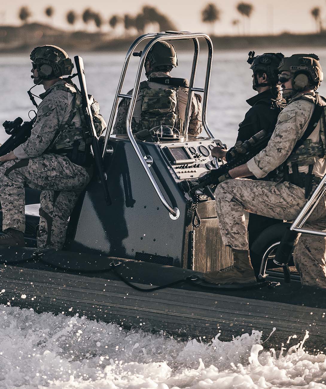 Soldiers navigating in rib boat using INVISIO Control app for Intercom management